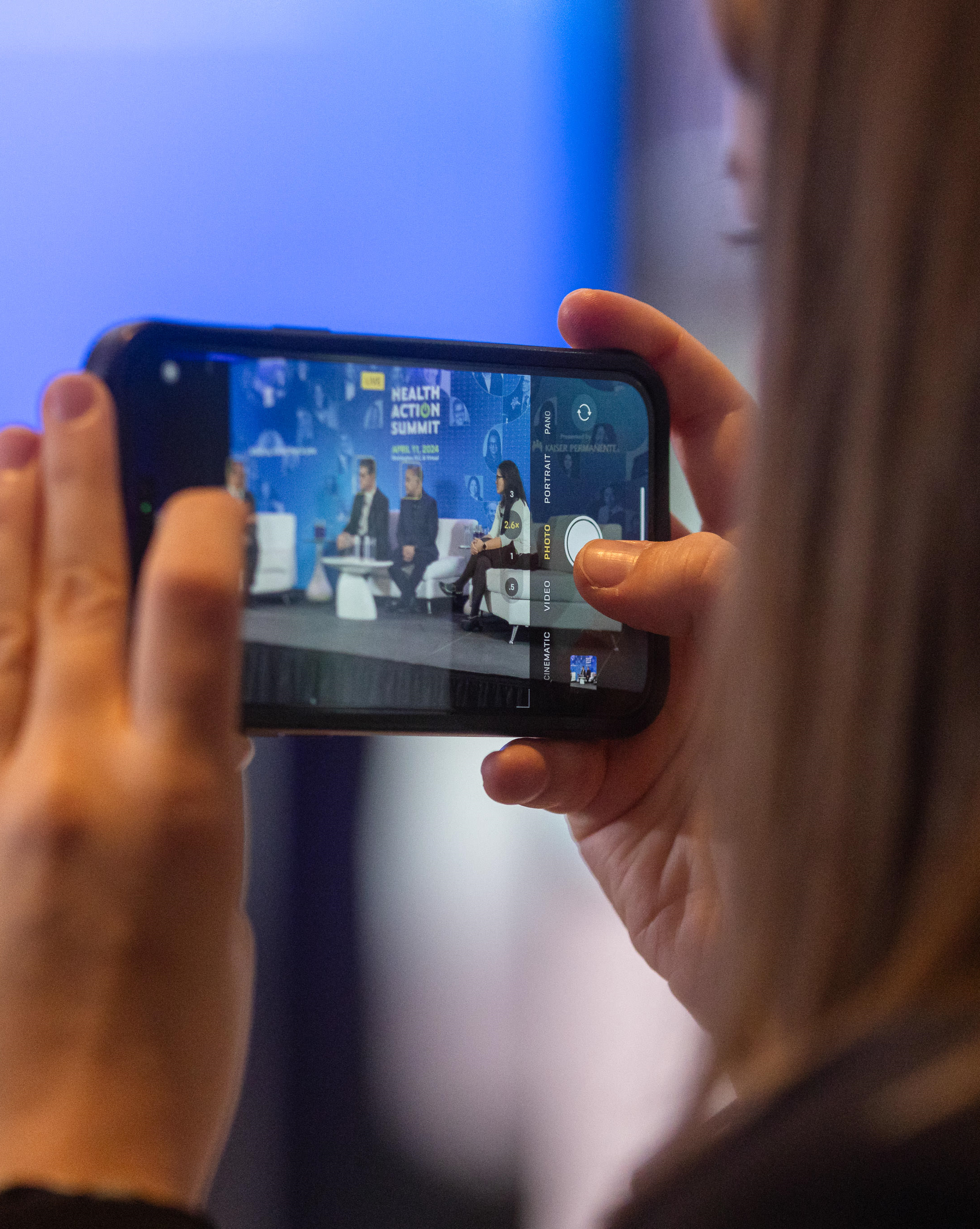 A women taking a video with her phone.